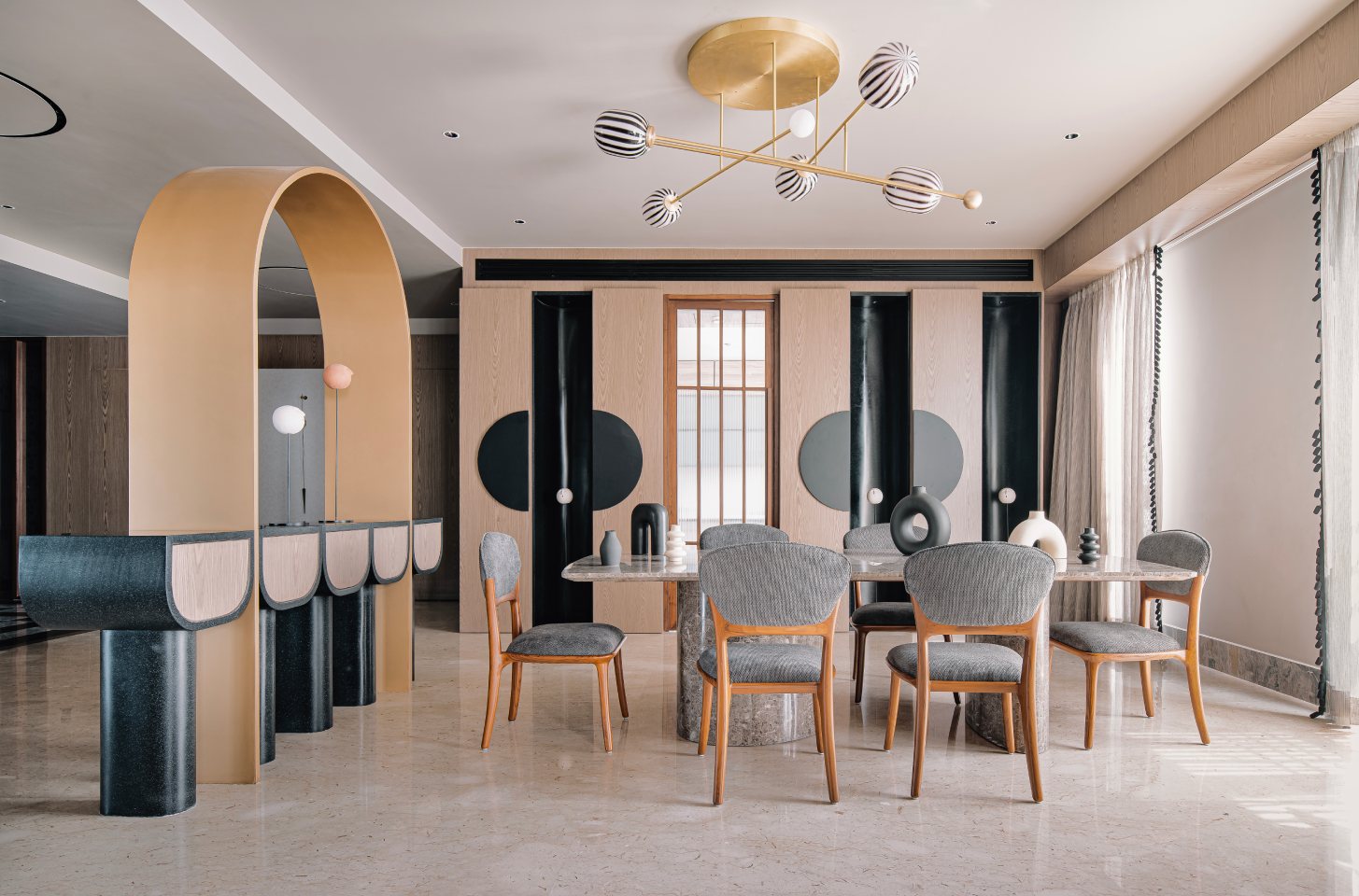 Elegant dining space featuring a modern chandelier with striped glass orbs.