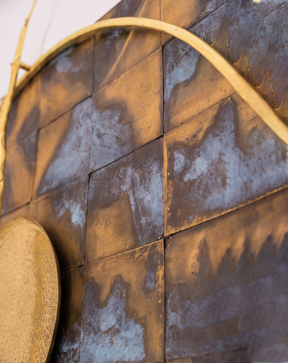 Close detail of hand-worked brass showing variations inherent to natural materials