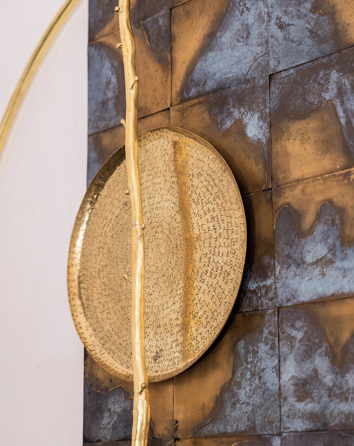 Branch-like brass detailing bridging organic form and geometric composition