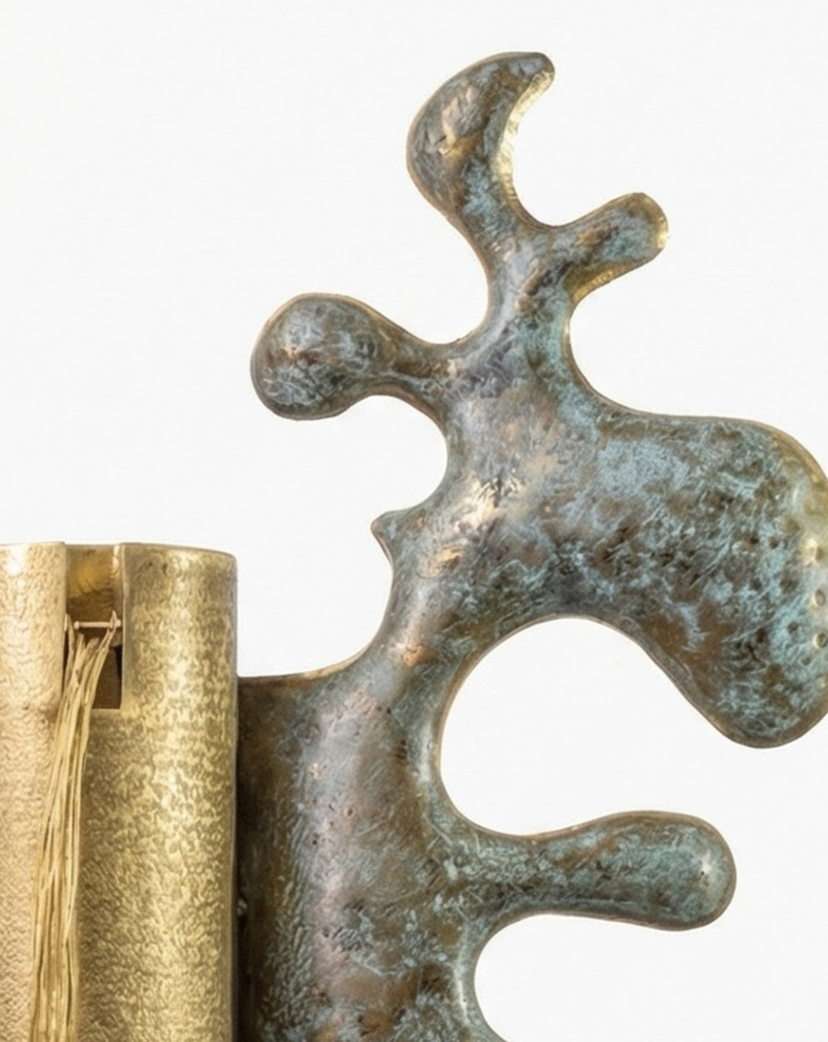 Rolled carpet form rendered in metal, revealing the knotted structure usually hidden at the back