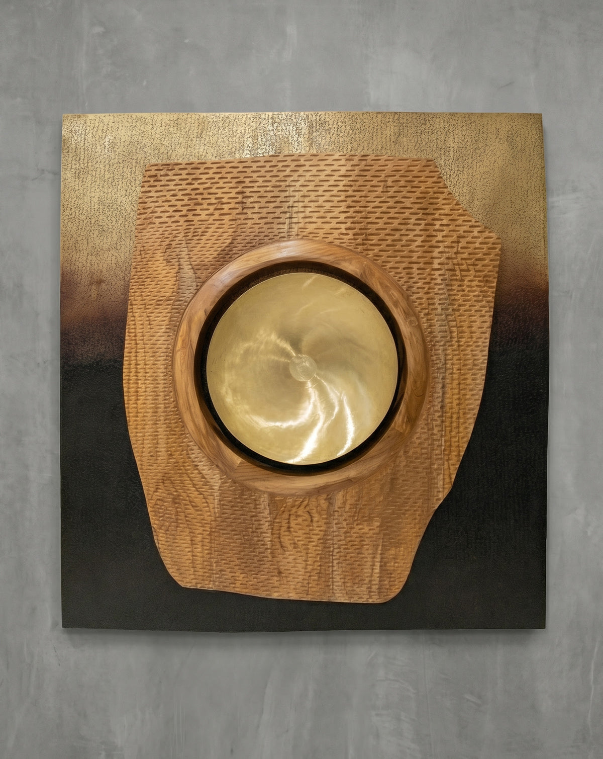 Smooth inset brass concavity at the centre, recessed to catch and reflect ambient light
