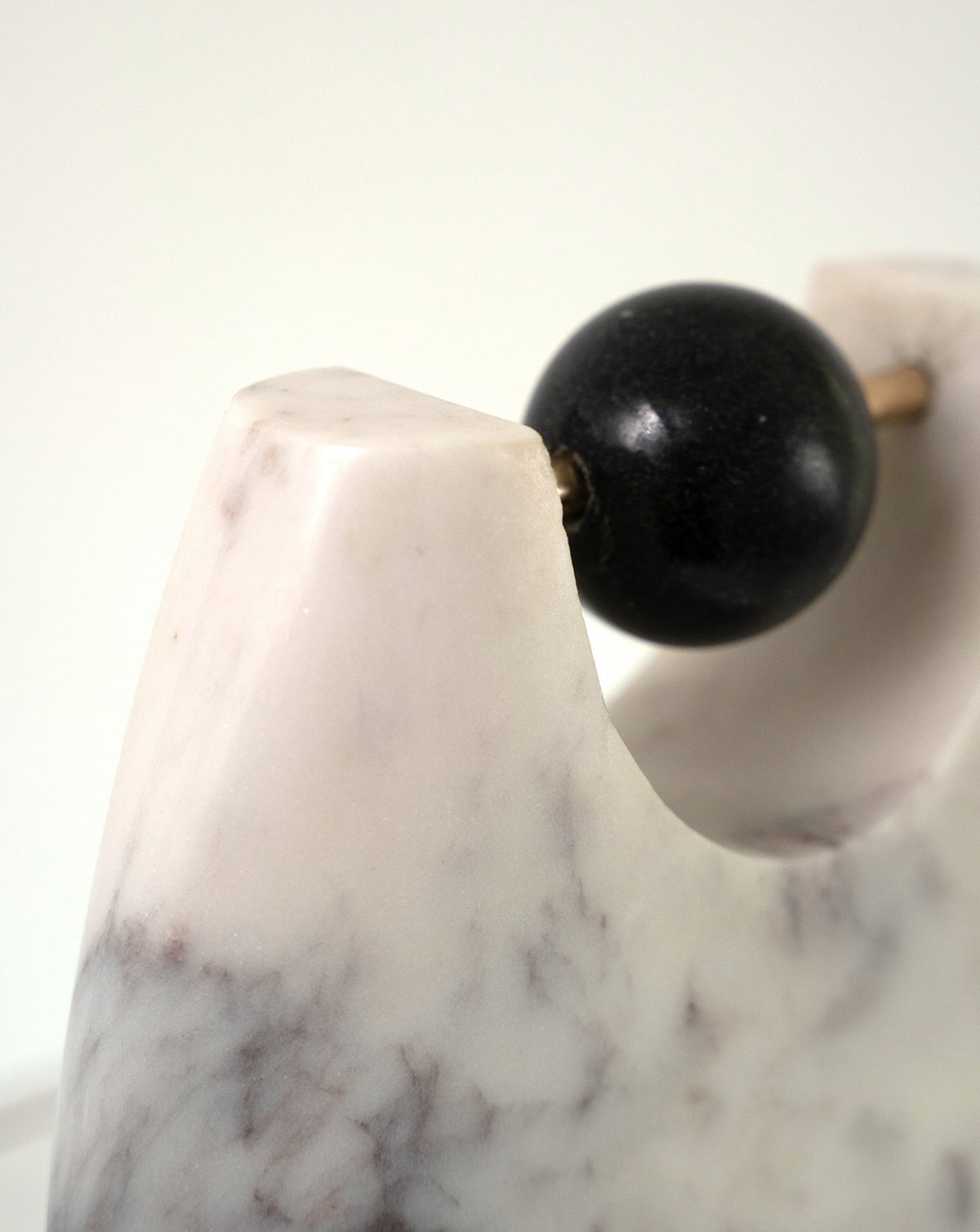 Rounded marble base rising into a U-shaped form, hand carved by Art Attaichi in India