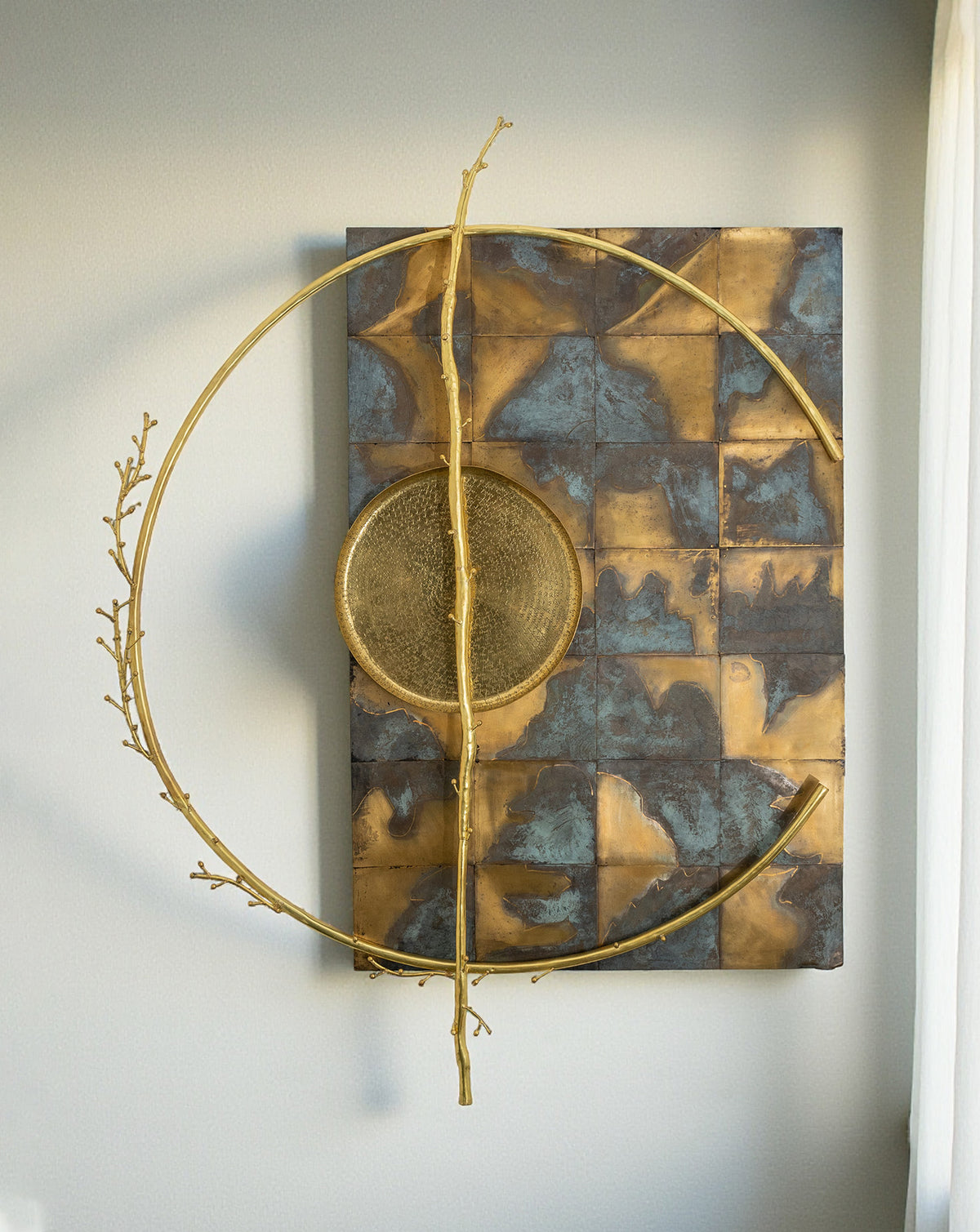 Patinated brass surface marking the passage of time across the circular sculptural frame
