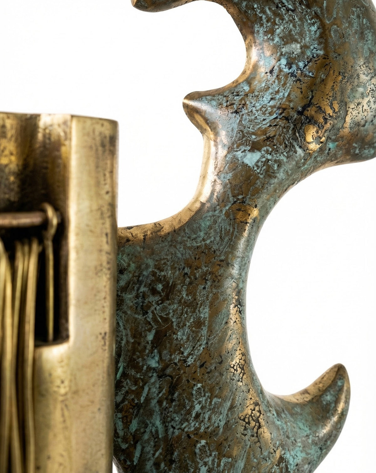 Fine brass strands echoing warp and weft threads across the sculpted body