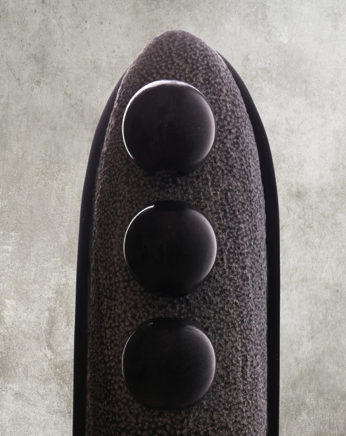 Sculpted stone volume shown from the rear, unadorned and purely minimal