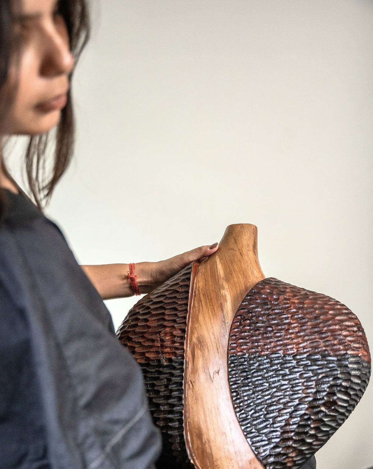 Natural teak tones and abstract shaping suited to contemporary and layered interiors