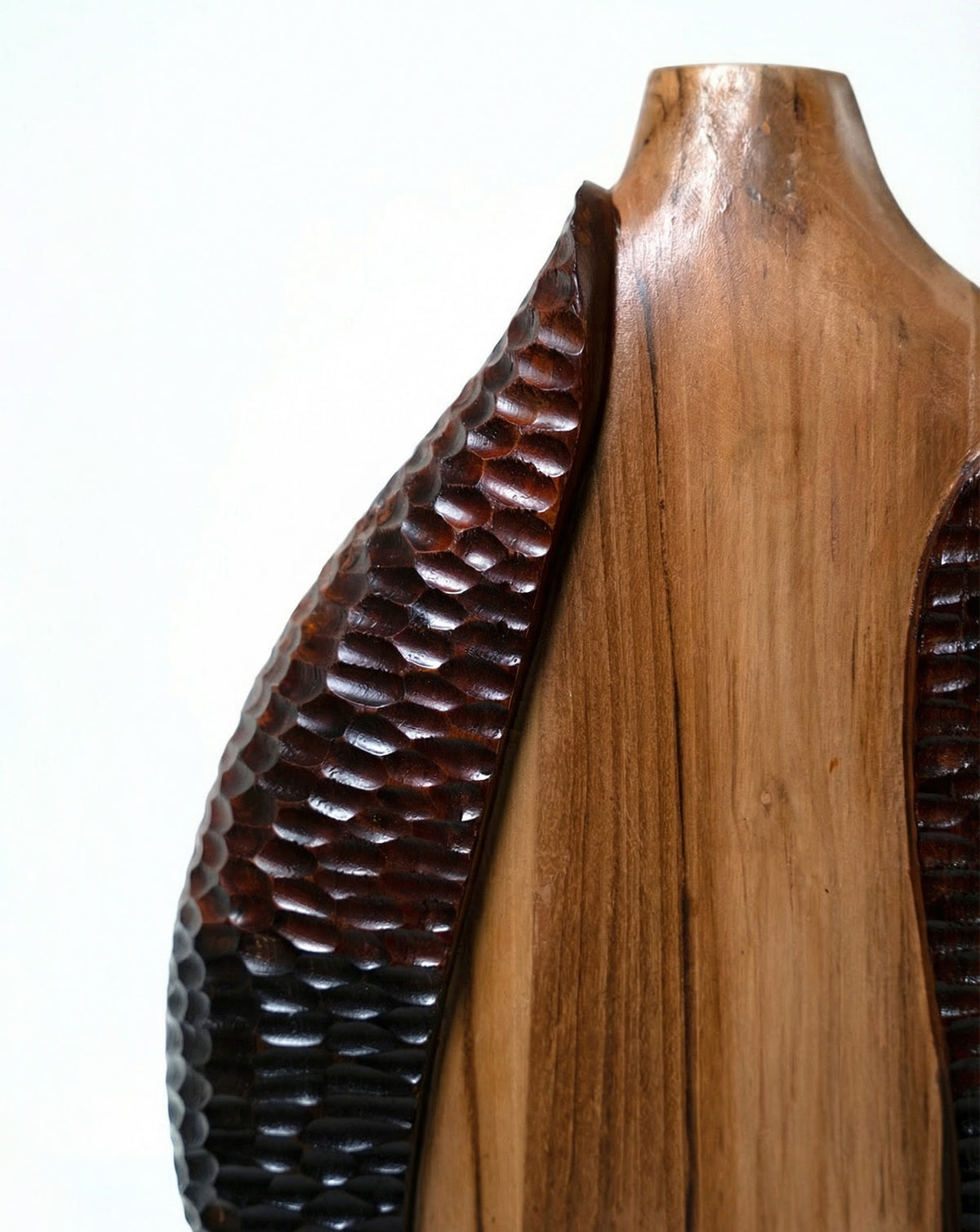 Angled view emphasising the dialogue between polished plane and carved texture