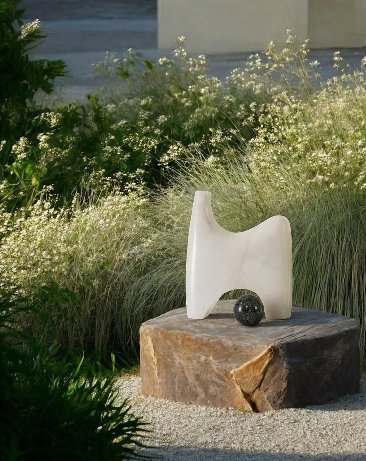 Asymmetrical arch-like marble form balanced on two grounded legs, made to order in India