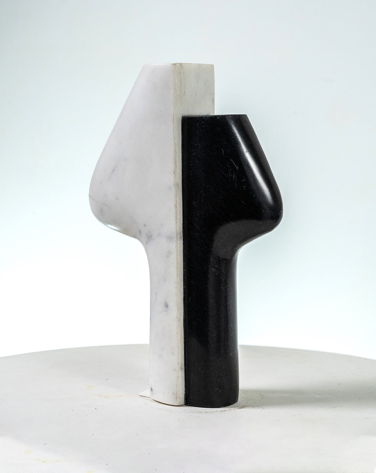 Hand carved solid marble vessel pairing dark and light stone in quiet contrast