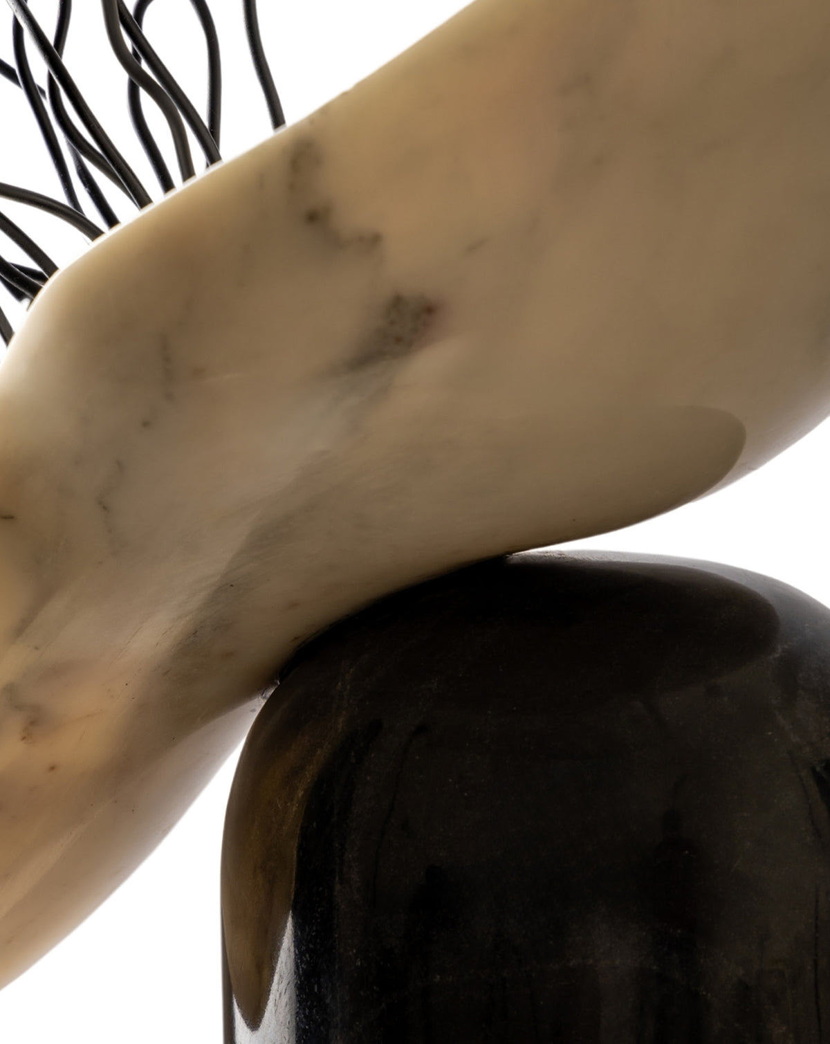 Polished marble surfaces meeting at a crisp edge, showing the duality of light and dark stone