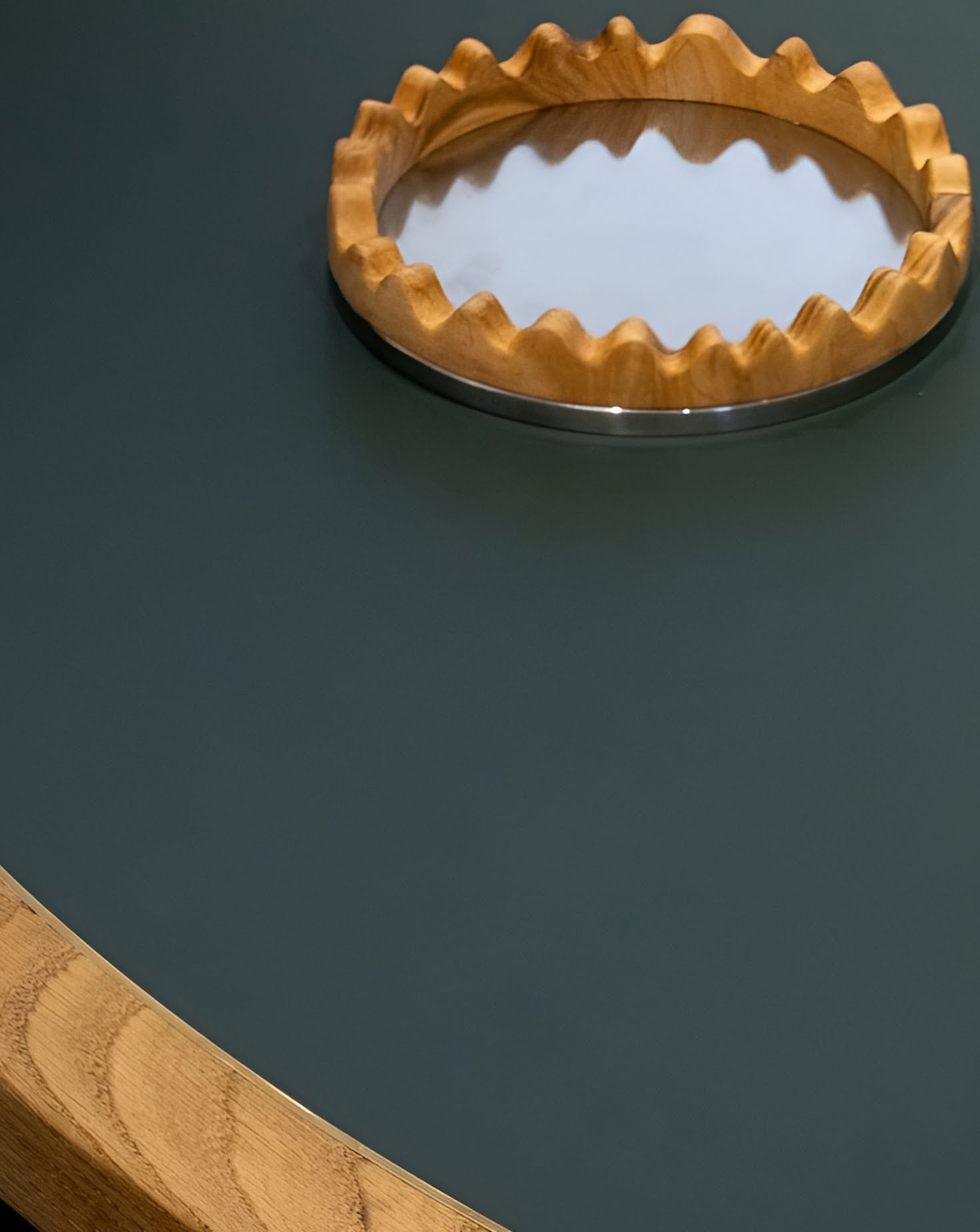 Wooden ring with a reflective surface on a dark green background