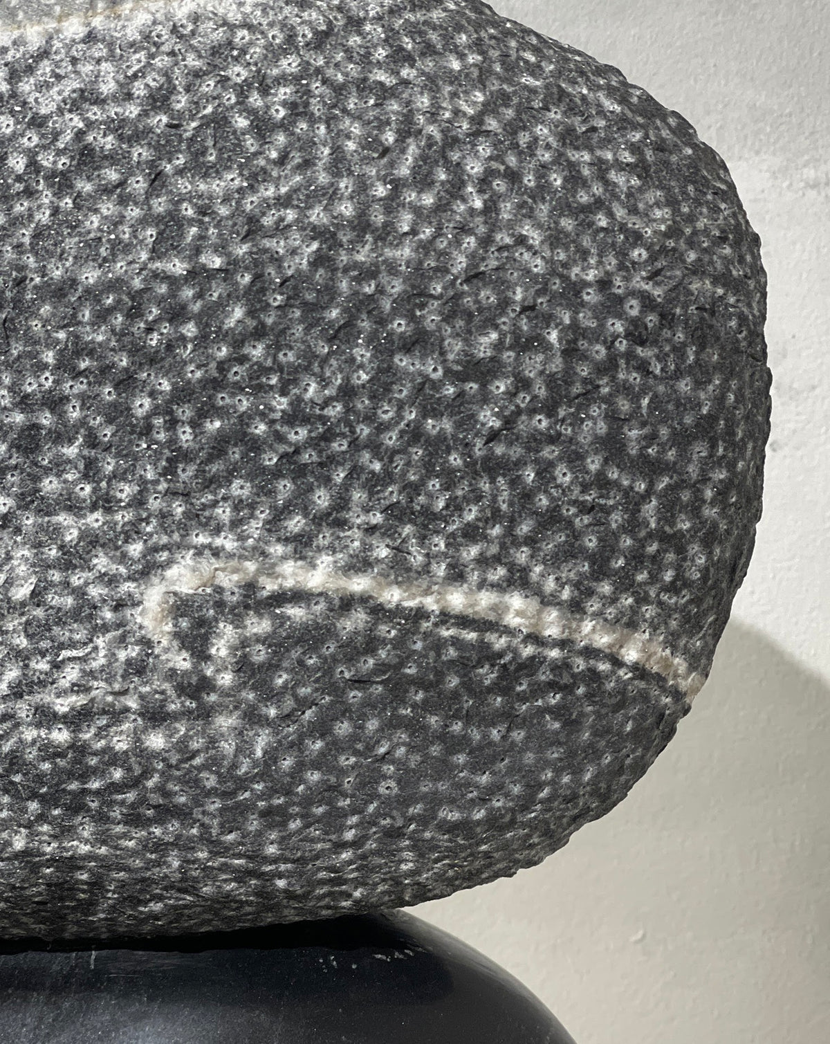 Close view of brass detailing contrasted against deep black stone