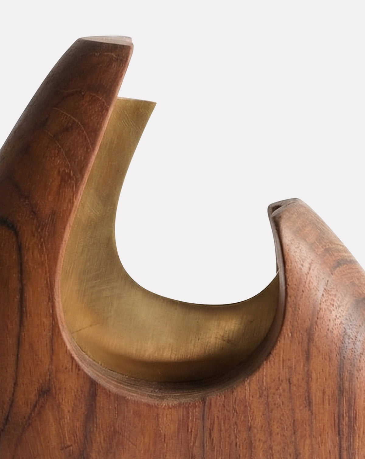 Carved interior revealing a soft brass lining for subtle contrast within the silhouette