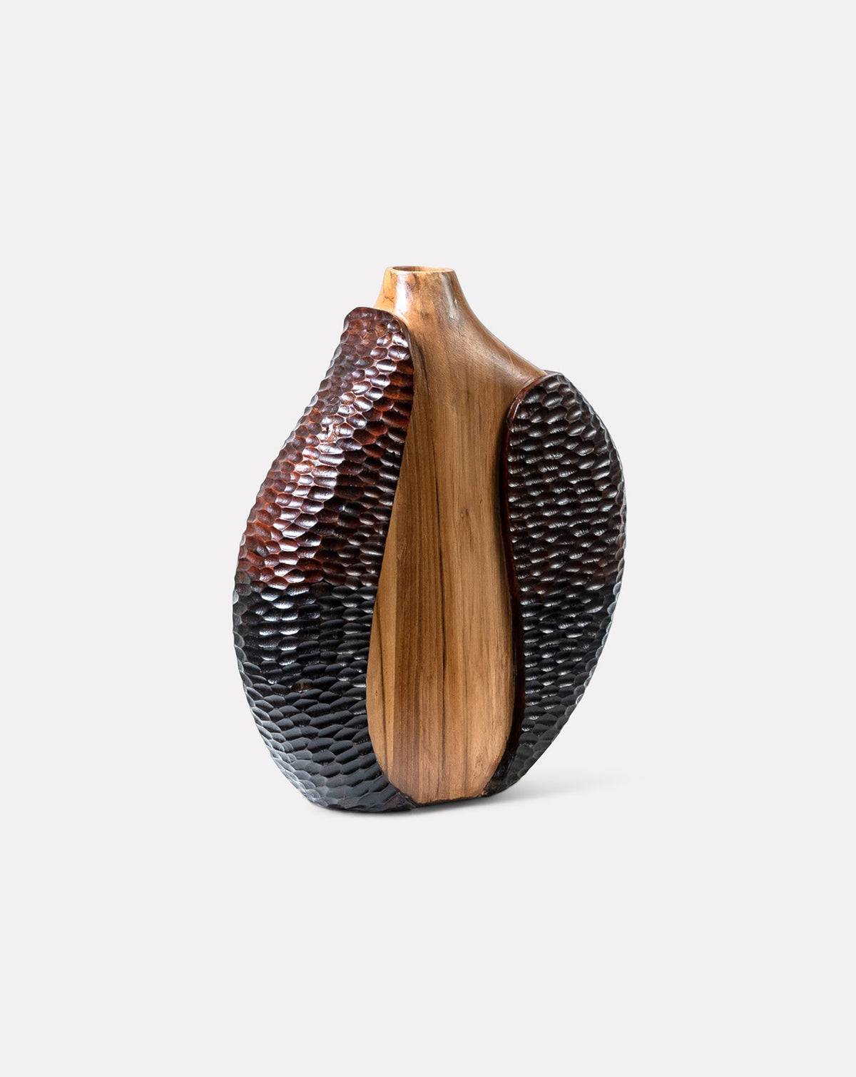 Smooth vertical plane intersecting textured carved surfaces on solid teak wood