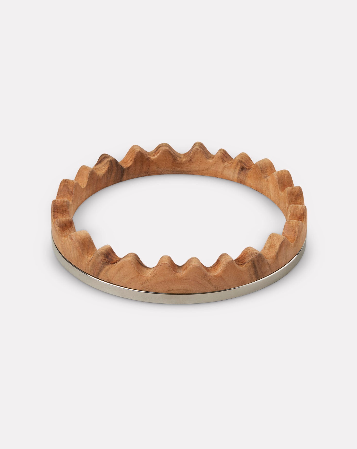 Wooden bracelet with a wavy design on a white background